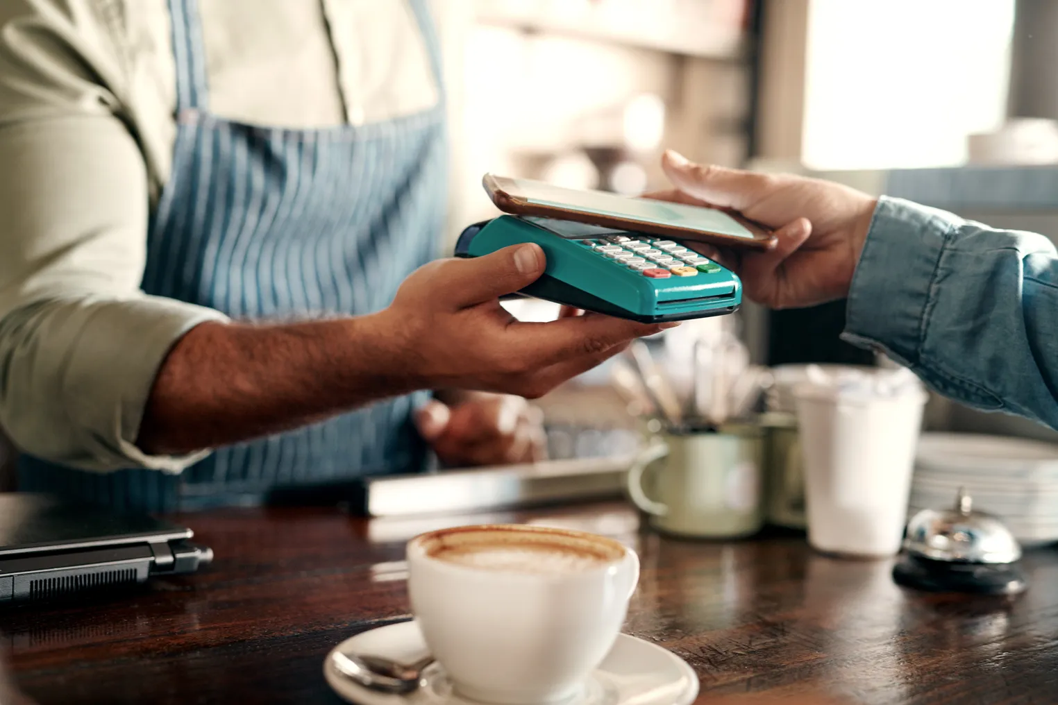 A customer pays for a purchase with a mobile device