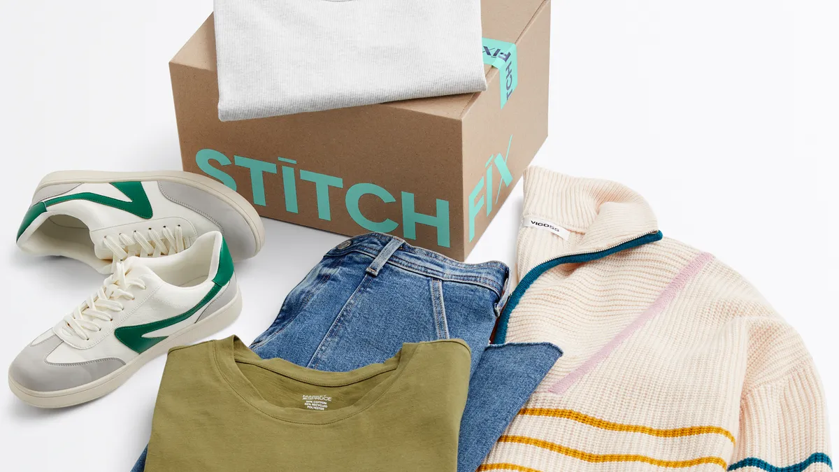 A cardboard box, pair of sneakers, sweater, shirts and jeans.