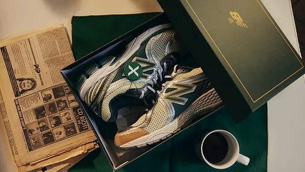 A pair of New Balance sneakers in a box on a table